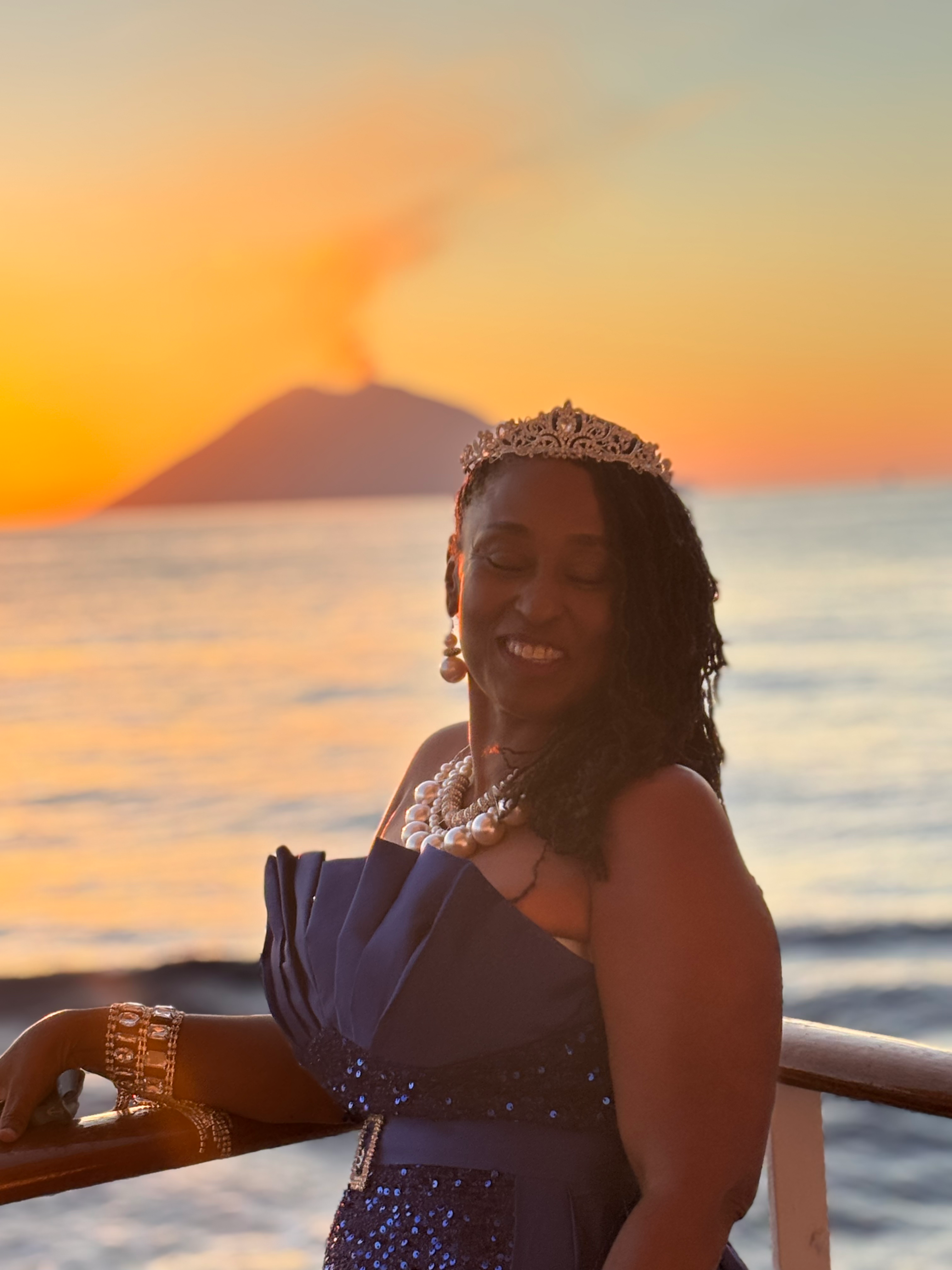 Tammy Johnson at sunset by the ocean in an elegant blue dress